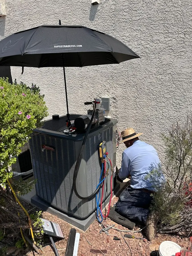 HVAC technician performing outdoor AC maintenance in Galt